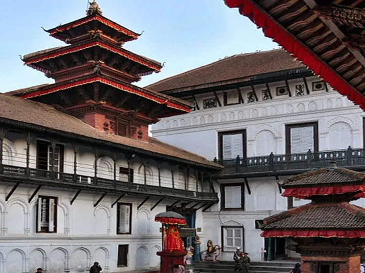 The historic white and dark wood courtyard architecture of the Hanuman Dhoka Royal Palace complex within Kathmandu Durbar.