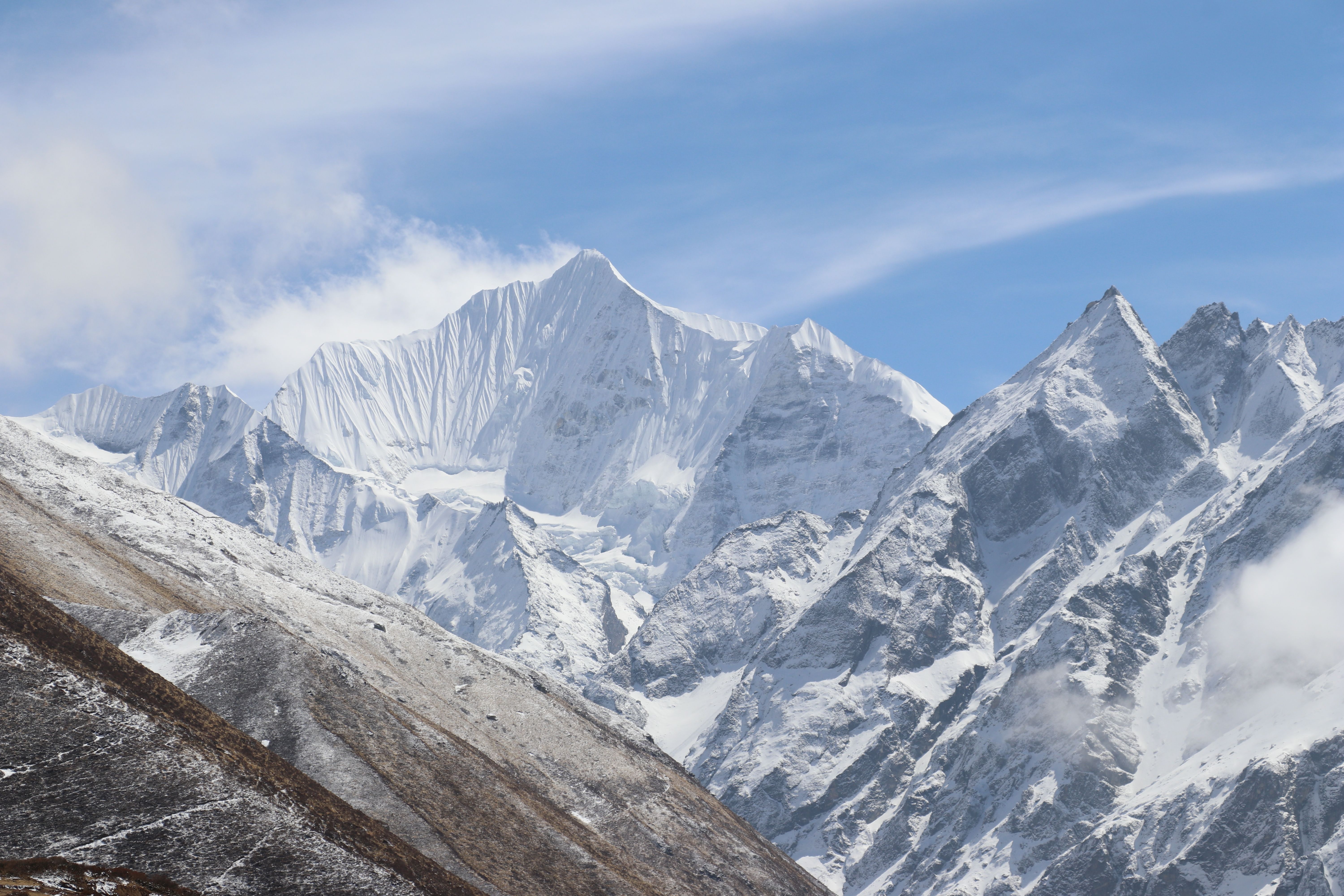 Snow-covered Himalayan peaks of the Langtang Lirung range rising sharply against a clear sky.