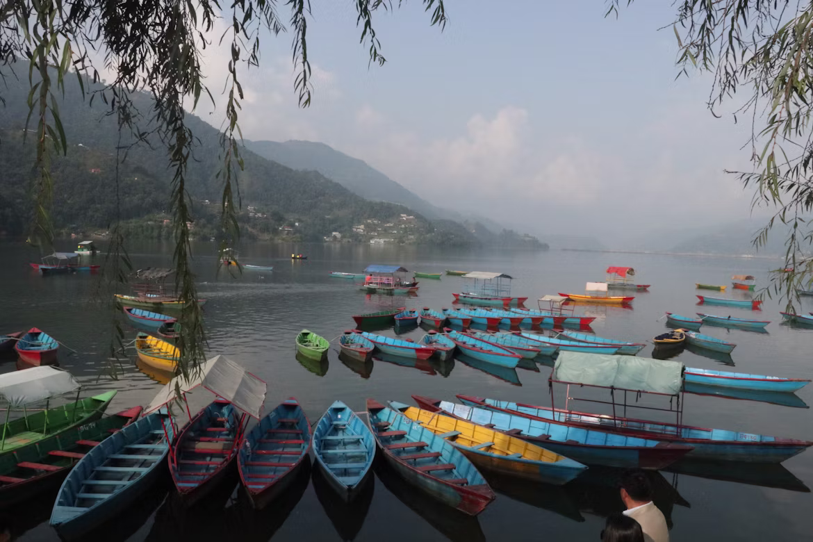 Moody, cloud-covered skies over Phewa Lake during a heavy monsoon rain in Pokhara.