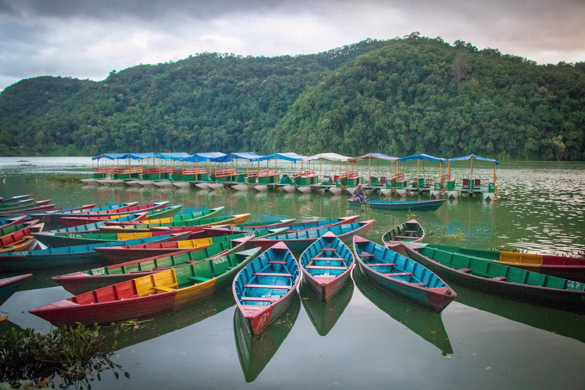Lush green lakeside landscapes and misty hills in Pokhara during the early monsoon month of June.