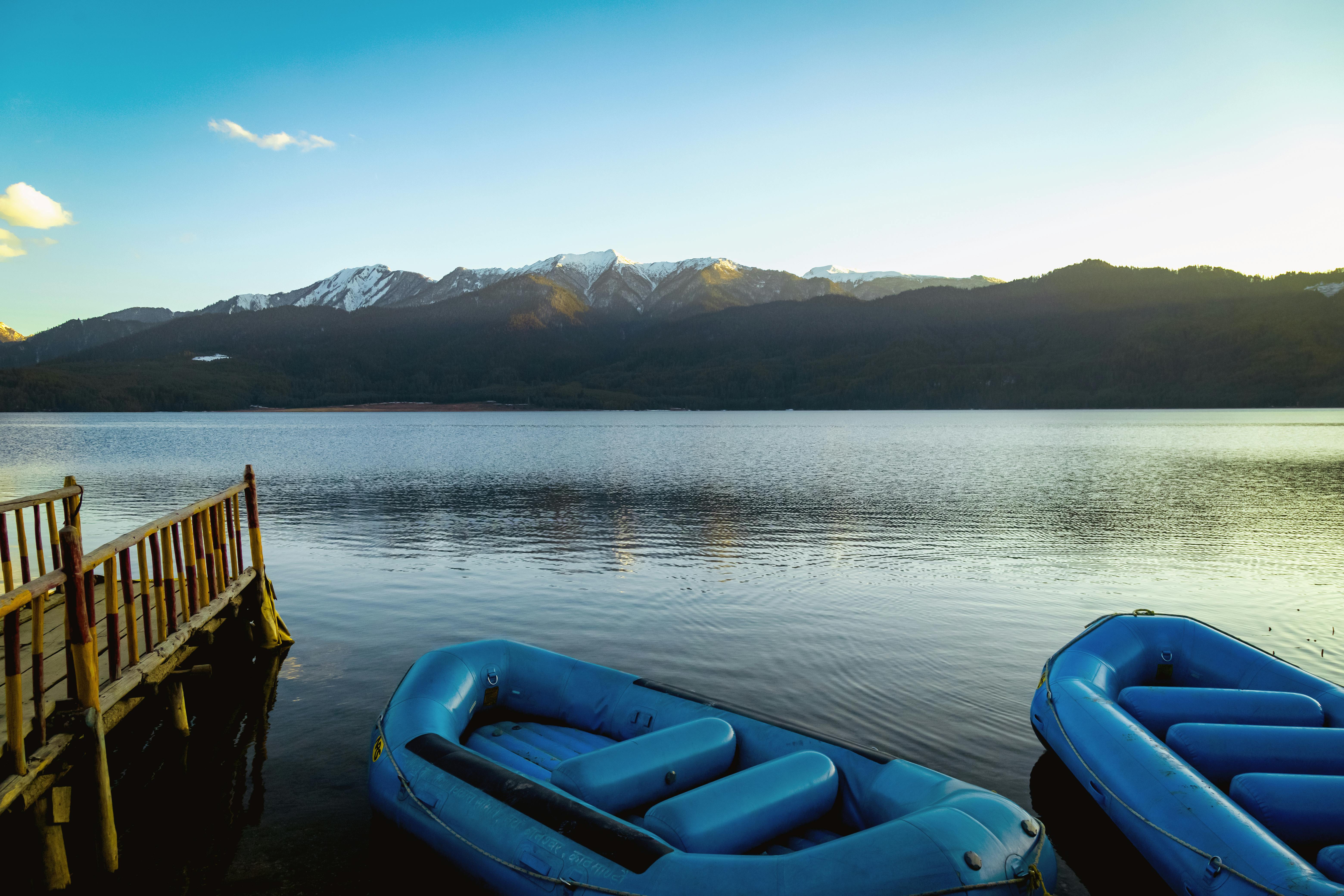 Rara Lake Peaceful scene of Rara Lake with blue inflatables and mountains in Nepal.