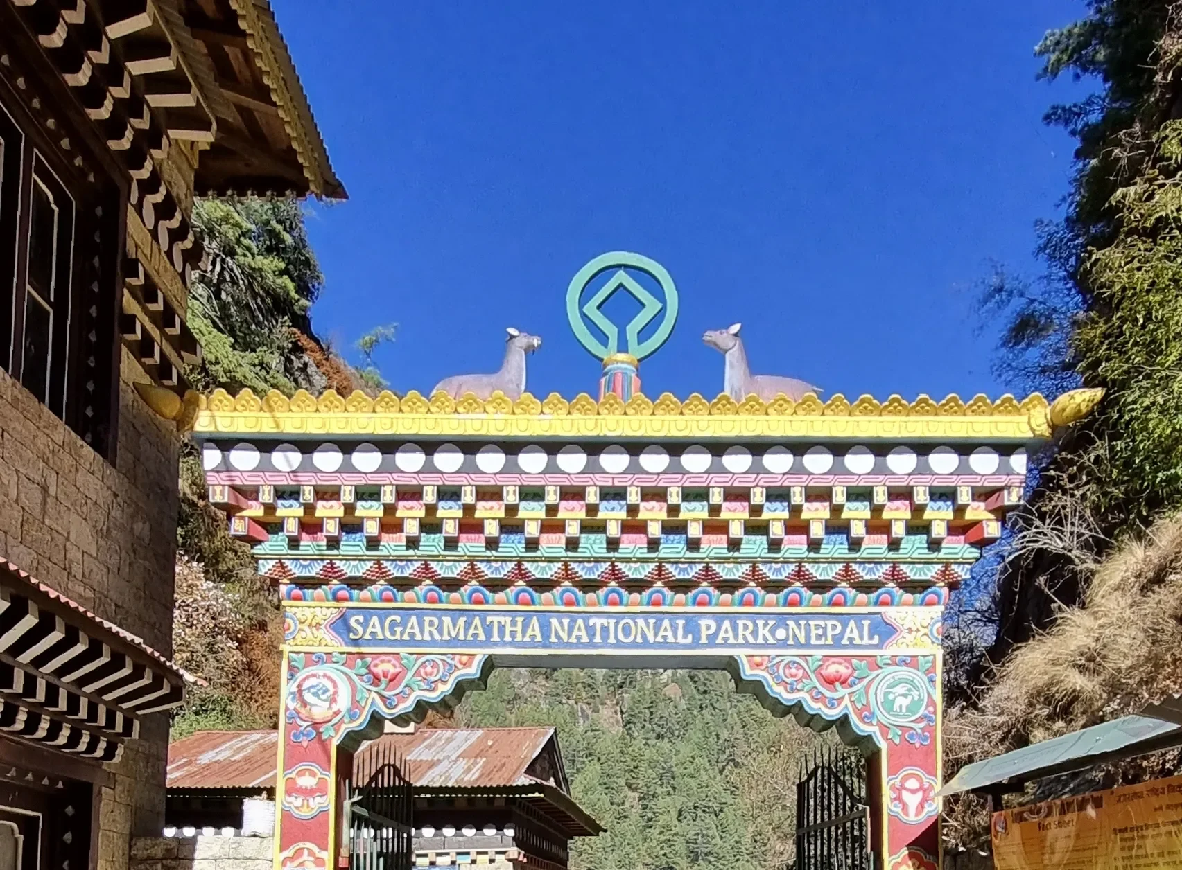 The brightly decorated traditional Buddhist-style entry archway of Sagarmatha National Park in Nepal against a clear blue sky